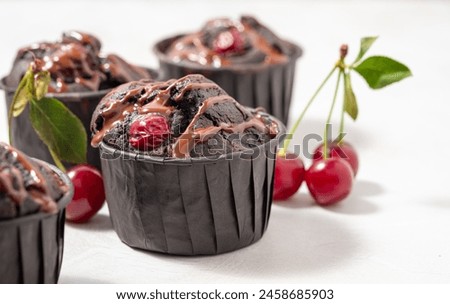 Chocolate muffins with cherry and chocolate drops