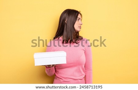 pretty woman on profile view thinking, imagining or daydreaming. white box packaging concept