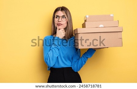 pretty woman thinking, feeling doubtful and confused packages boxes concept