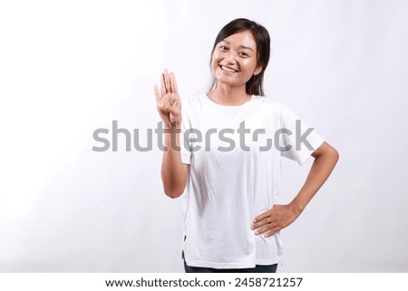 Smiling happy good-looking asian girl giving advice, showing four fingers as explain rules, make point, standing white background