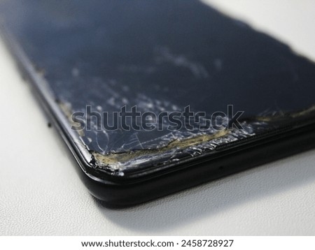 Mobile smartphone with broken screen isolated on white.