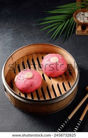 Pink bao buns shaped like pigs in a bamboo steamer; a playful and appetizing Asian culinary creation.