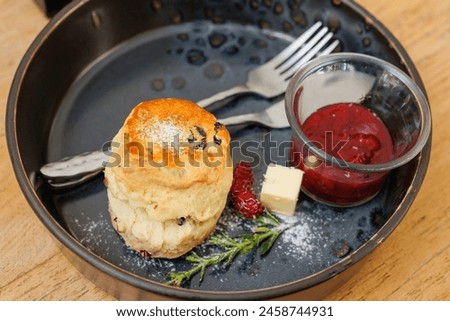 Scones with Strawberry Jam English style traditional quick bread menu served on wooden table Royalty-Free Stock Photo #2458744931