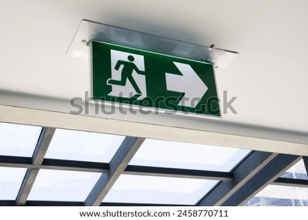 Emergency Fire exit sign at  the corridor in building
