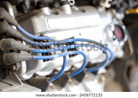 Connections of Power: Captivating Shot of Engine and Plug Wires Royalty-Free Stock Photo #2458772135