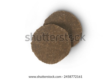 Two dried rotten beans sheets, ingredient in northern of Thai food, made from fermented soybeans, similar to natto, isolated on white background with clipping path, top view, tr flat lay. Royalty-Free Stock Photo #2458772161