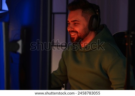 Man playing video games on computer indoors