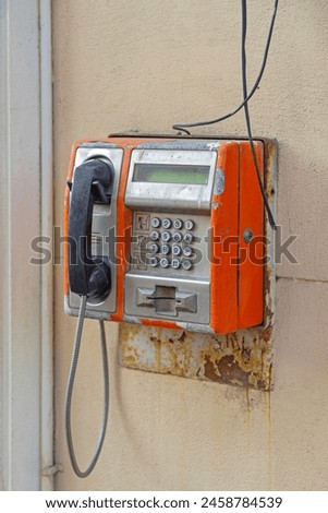 Old Rusty Card Payphone Public Telephone at Building Wall Royalty-Free Stock Photo #2458784539