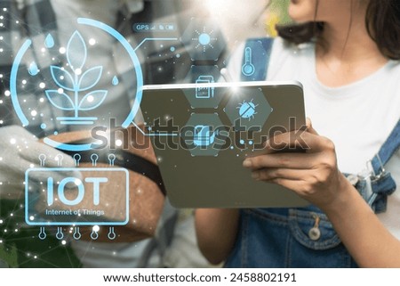 Smart farming technology,business,industry agriculture food concept,young farmer using interface screens in greenhouse,checking order online,monitor agricultural products,with artificial intelligence
