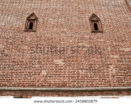 Two loopholes in the old fortress wall Royalty-Free Stock Photo #2458802879