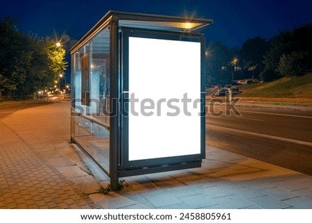 Mockup Of Bus Stop Advertising Billboard On A City Street At Night. Outdoor Poster Lightbox With Car Light Trails In The Background Royalty-Free Stock Photo #2458805961