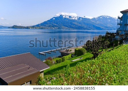 Wide angle view of scenic rural landscape with Lake Lucerne seen from hiking trail at Kehrsiten on sunny spring day. Photo taken April 11th, 2024, Kehrsiten, Switzerland.