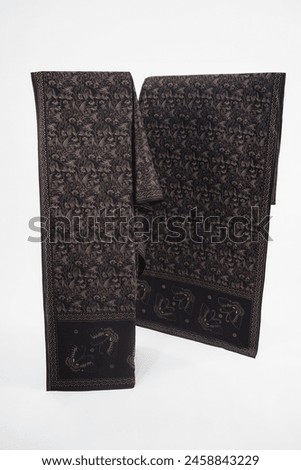 Indonesia traditional black batik fabric with a tortilla brown heron motif, symbolizing nature's beauty and grace, creates a captivating and luxurious look, blending tradition with modern style.