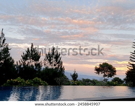 A calm swimming pool with mountain peaks view