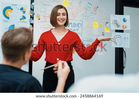 Closeup image of male project manager raise hand to ask questions while young beautiful leader presents business project with confident by using mind map and colorful sticky notes. Immaculate. Royalty-Free Stock Photo #2458864169