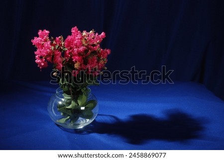 Still life photography with Colorful flowers on old wooden table. The table is covered with a cloth
