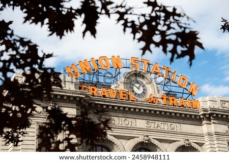 Historic Denver Union Station sign through autumn leaves