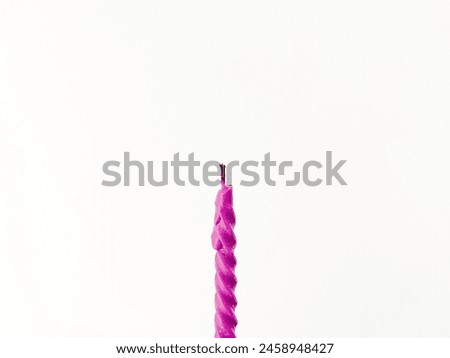 Image of a purple birthday candle in an isolated white background