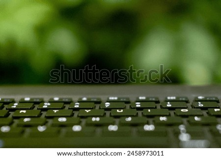 Close up Photo of Keyboard with Green Leaves Background