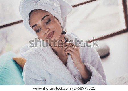 Photo portrait of attractive young woman neck skin roller massager wrapped towel dressed bath robe home interior enjoy weekend