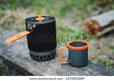 Camping utensils, a pot with a mug, a cooking system, a set of camping utensils. High quality photo