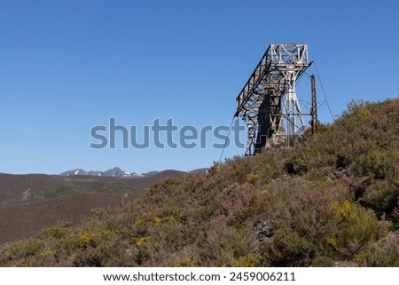 Metal structure tower with concrete base from coal mine cable cart industrial abandoned cableway on a spring sunny day in Tormaleo province of Asturias Spain Royalty-Free Stock Photo #2459006211