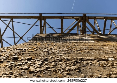 Metal structure tower with concrete base from coal mine cable cart industrial abandoned cableway on a spring sunny day in Tormaleo province of Asturias Spain Royalty-Free Stock Photo #2459006227