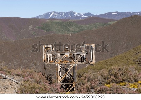 Metal structure tower with concrete base from coal mine cable cart industrial abandoned cableway on a spring sunny day in Tormaleo province of Asturias Spain Royalty-Free Stock Photo #2459008223