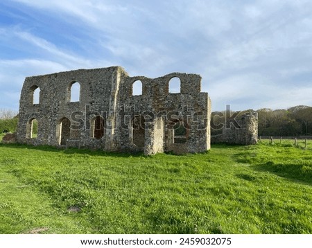 Greyfriers Medieval friary near Dunwich in Suffolk, with empty windows and broken down stone walls, very little remains of this ancient monument. Royalty-Free Stock Photo #2459032075