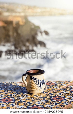 traditional Mexican cup made of clay facing the sea, Mexican coffee cup Royalty-Free Stock Photo #2459035995