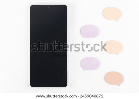 Smartphone and sticky notes with speech bubbles. SNS image