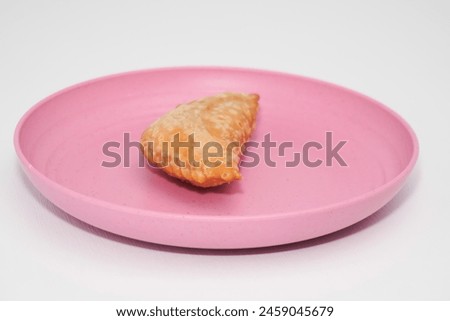 The market snack is called pastel cake which is in a container with a white background