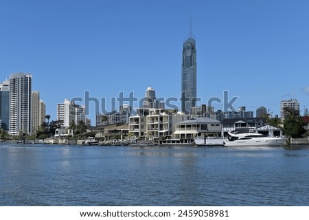 Luxury house on Nerang river against Surfers Paradise skyline the Gold Coast's entertainment and tourism centre. Royalty-Free Stock Photo #2459058981