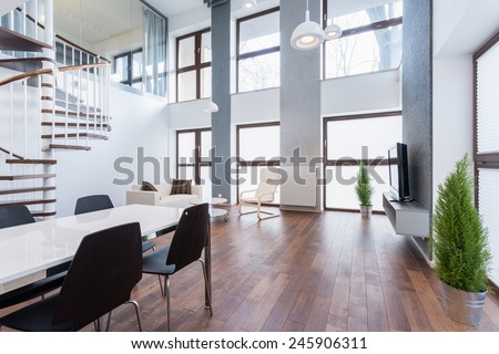 Spacious family room with wooden parquet and big windows Royalty-Free Stock Photo #245906311