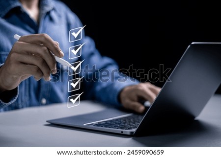 Checklist concept, businessman use laptop to taking online checklist survey on virtual screen, filling out digital form checklist.