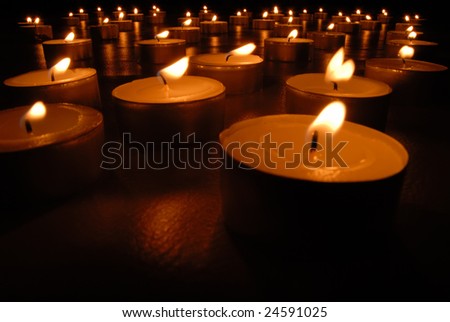 Close up picture of a carpet of many little candles