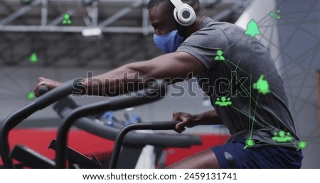 Image of network of connections with icons over african american man at gym. Global connections and digital interface concept digitally generated image.