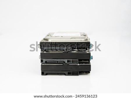 Stack of computer internal 3.5 inch hard disk drives on isolated white background
