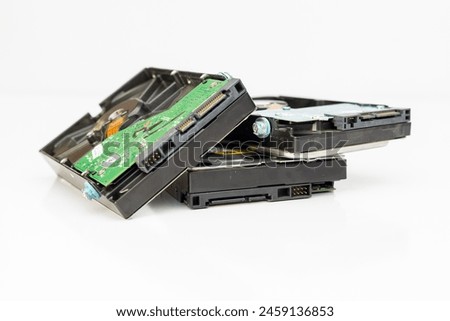 A heap of 3.5 inch internal hard disk drives for storage data isolated on white background