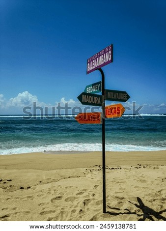 Pole direction sign at Balekambang Beach, Indonesia.