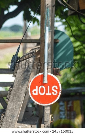 a stop sign that hangs on a railroad crossing