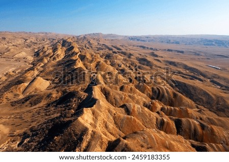 Aerial view of a vast mountain range spreading across the arid desert landscape of Georgia.