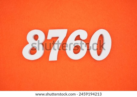 The number 8760 is made from white painted wood placed on a background of orange paper.