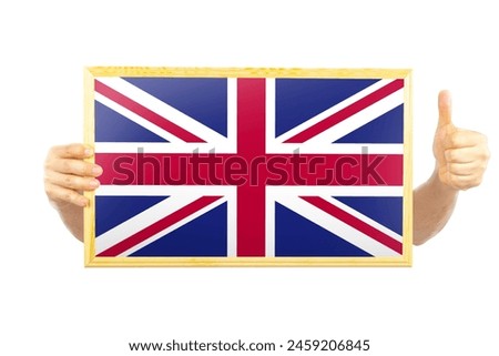 Hands holding a frame with United Kingdom flag, independence day idea, approvement or success in United Kingdom, two hands and thumb up, celebration or victory concept