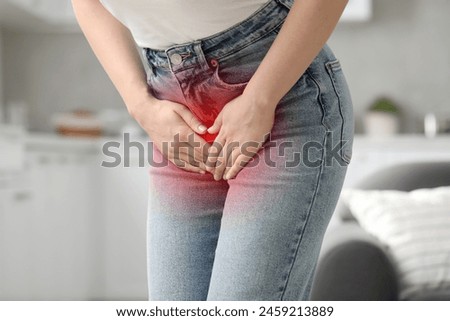 Woman suffering from cystitis symptoms indoors, closeup Royalty-Free Stock Photo #2459213889