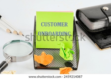 Concept Business. CUSTOMER ONBOARDING symbol on a green sticker next to the business accessories