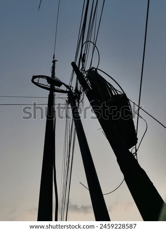 a perspective photograph of a power cord post on the edge of town Royalty-Free Stock Photo #2459228587