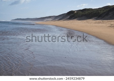 Landscape photo of coast of Mozambique ocean in Africa. Xai Xai coastline in Mozambique. Mozambique ocean with beach and mountains and sky