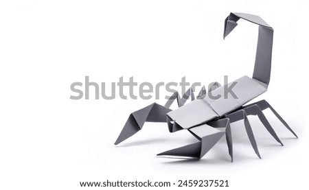 Animal concept paper origami isolated on white background of a scorpion arachnid with claws, pinchers and stinger with copy space, simple starter craft for kids for weekend entertainment
