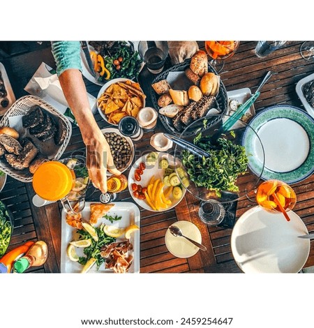 An elegantly set table showcases an assortment of delectable dishes, promising a culinary journey of flavors and aromas, a feast for both the eyes and the palate. Royalty-Free Stock Photo #2459254647